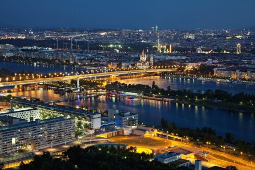 Areal view of a city at night at a river and shimmering street lights