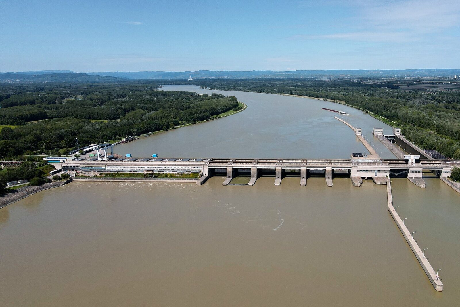 a brown river with a bridge crossing it